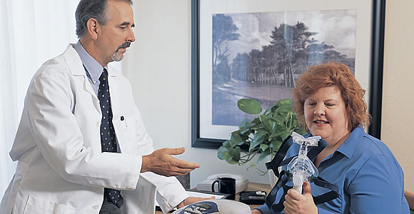 Sleep Disorder Treatment Physician Discussing CPAP Face Mask With Patient