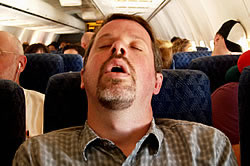 Tired Airline Passenger Sleeping during Flight