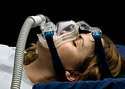 Female Demonstrating How a CPAP Face Mask is Installed and Used